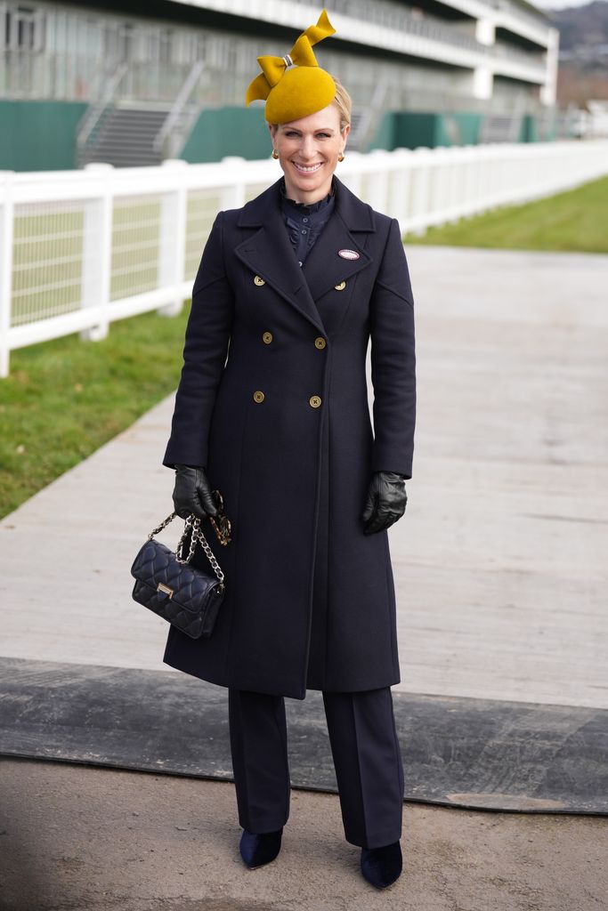 Zara Tindall layered with leather gloves and a vibrant yellow hat at Cheltenham