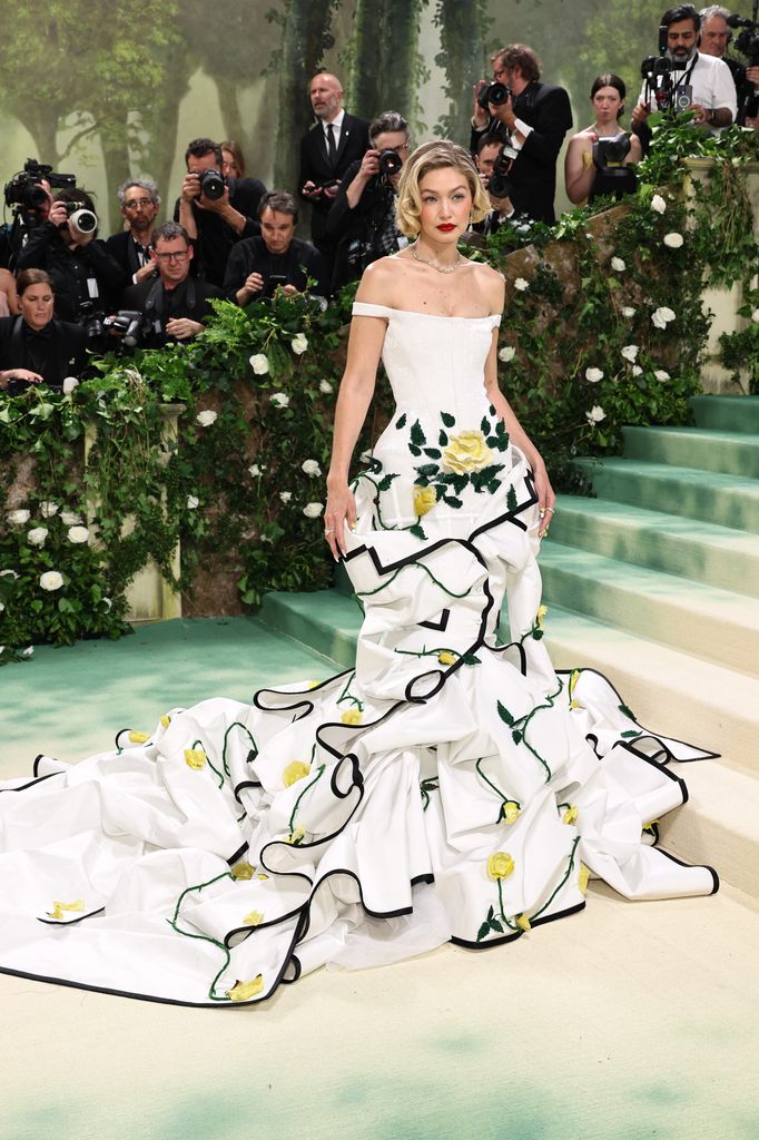 Gigi Hadid stunned in a floral embroidered Thom Browne gown with a dramatic train at the 2023 Met Gala.