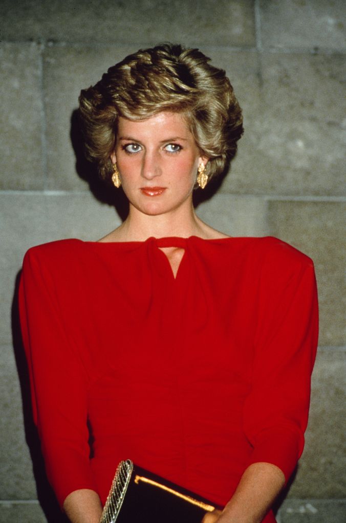 Princess Diana wearing a red shoulder pad dress
