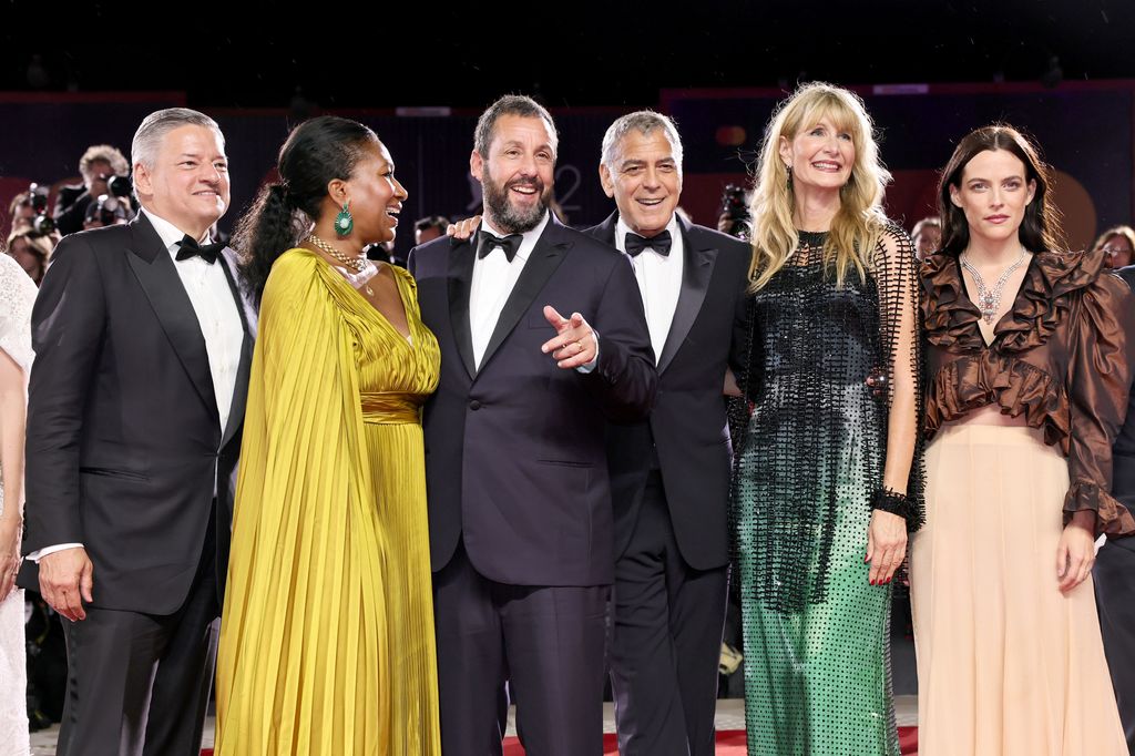 Ted Sarandos, Nicole Avant, Adam Sandler, George Clooney,  Laura Dern and Riley Keough attend the "Jay Kelly" red carpet during the 82nd Venice International Film Festival on August 28, 2025 in Venice, Italy