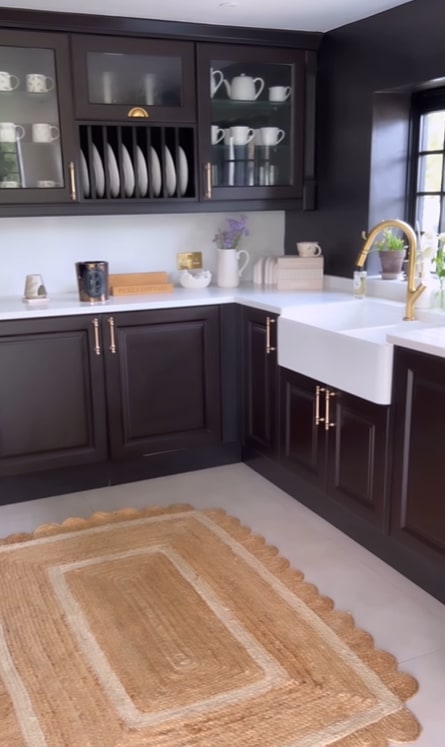 black kitchen with jute rug
