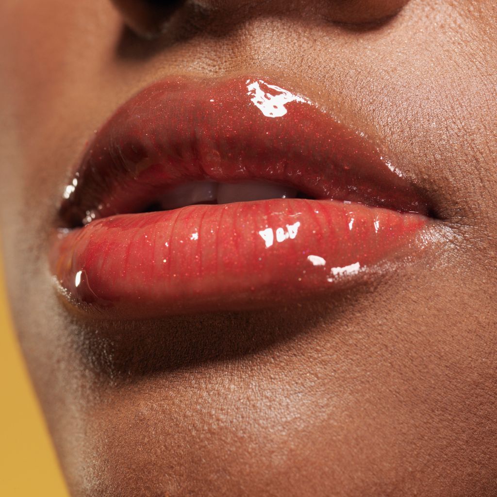 Lips of young woman with high shine 