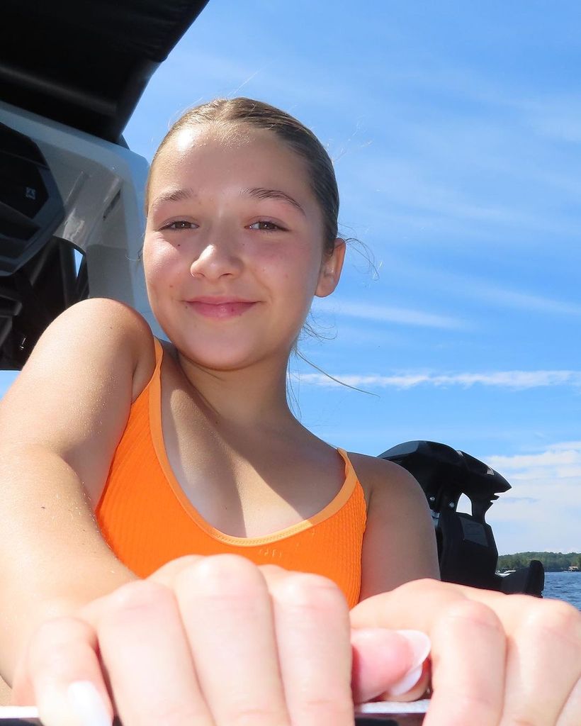harper beckham wearing orange swimsuit 