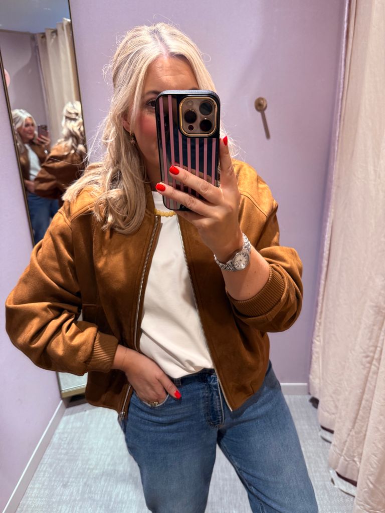 Shopping expert Leanne Bayley wearing a suedette bomber jacket from Marks & Spencer. She's styling it with jeans and a white tee.