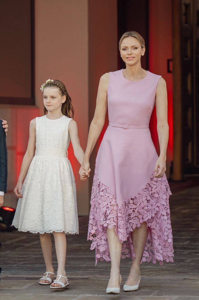 Princess Gabriella in white dress with Princess Charlene in pink dress