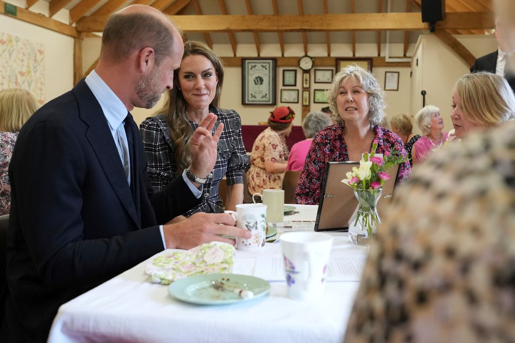 SUNNINGDALE, ENGLAND - SEPTEMBER 8: Catherine, Princess of Wales and Prince William, Prince of Wales speak to members as they visit the National Federation of Women's Institute (WI) to commemorate the three-year anniversary of the death of Queen Elizabeth II on September 8, 2025 in Sunningdale, England. (Photo by Alastair Grant - WPA Pool/Getty Images)