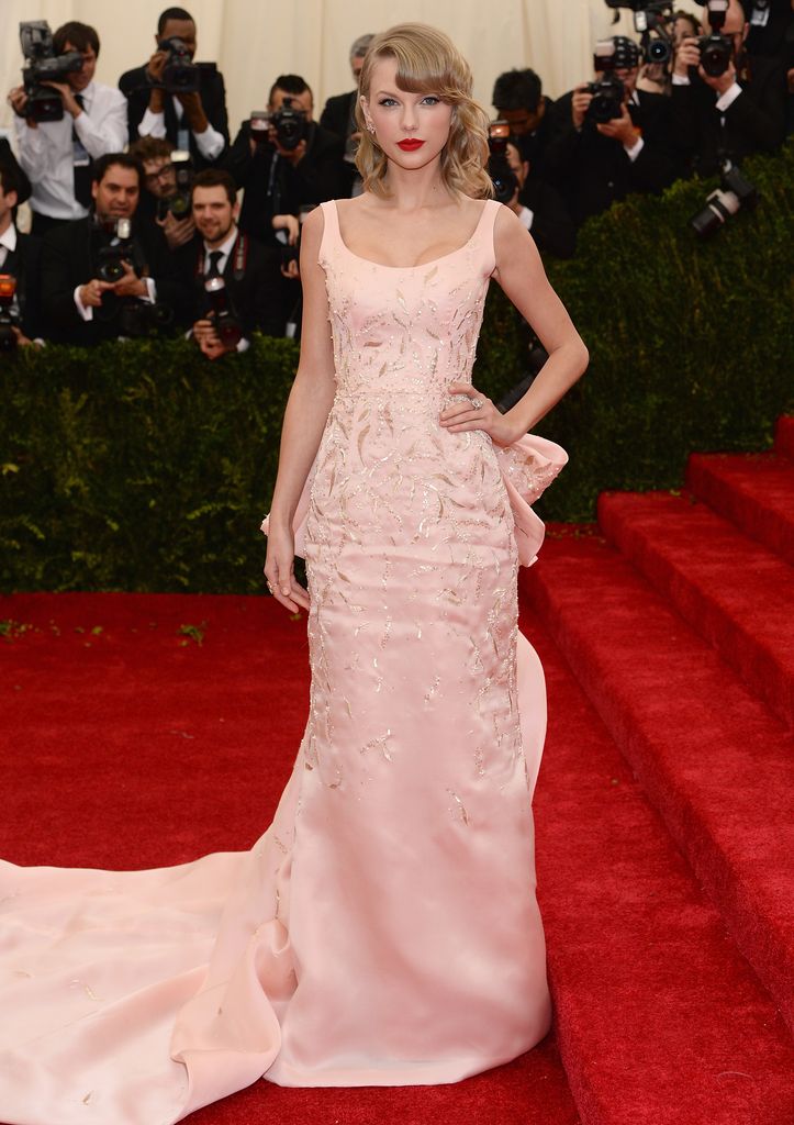Taylor Swift wore a pink embroidered Oscar de la Renta gown with a train to the 2014 Met Gala.