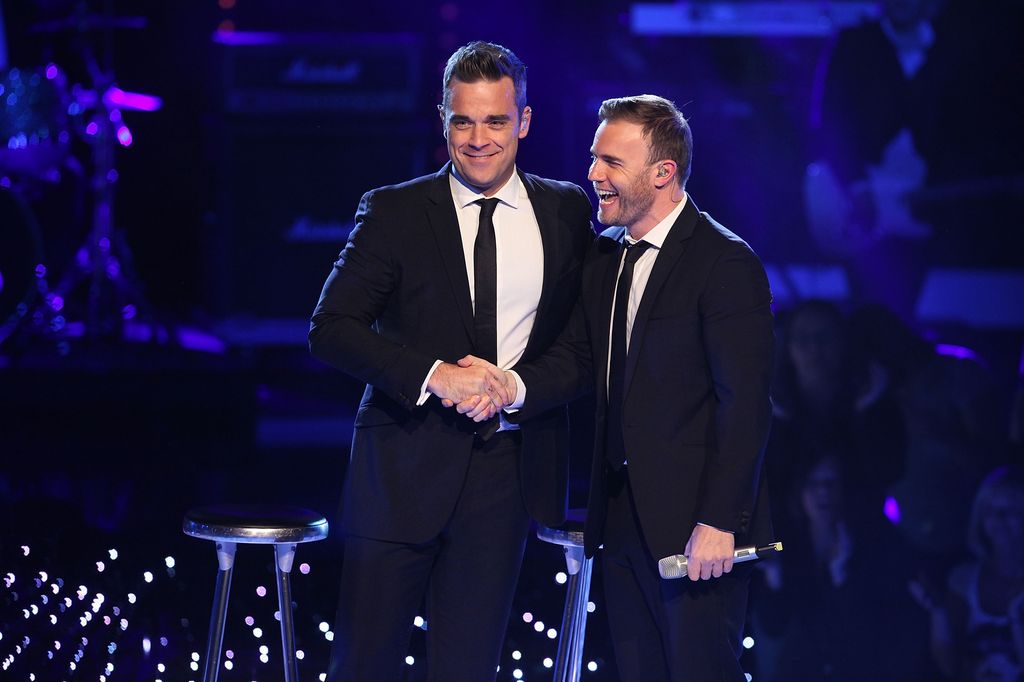 Robbie Williams and Gary Barlow perform on stage during the Popstars Live Show 