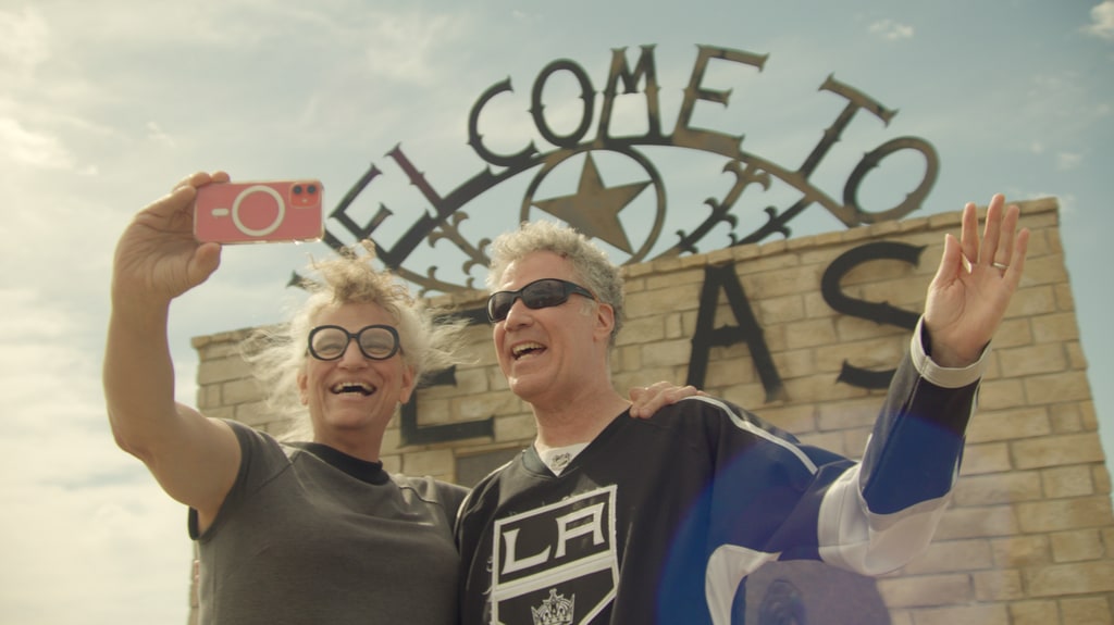 Harper Steele and Will Ferrell taking a selfie outside a sign in Texas