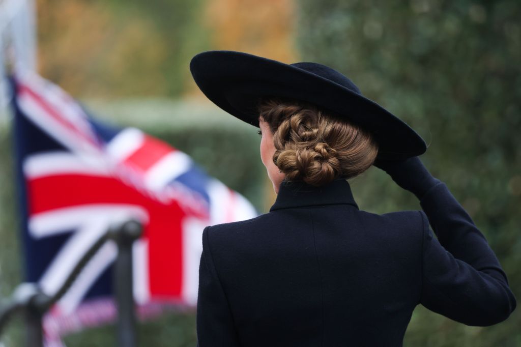 The Princess of Wales saluting the Union Jack from behind