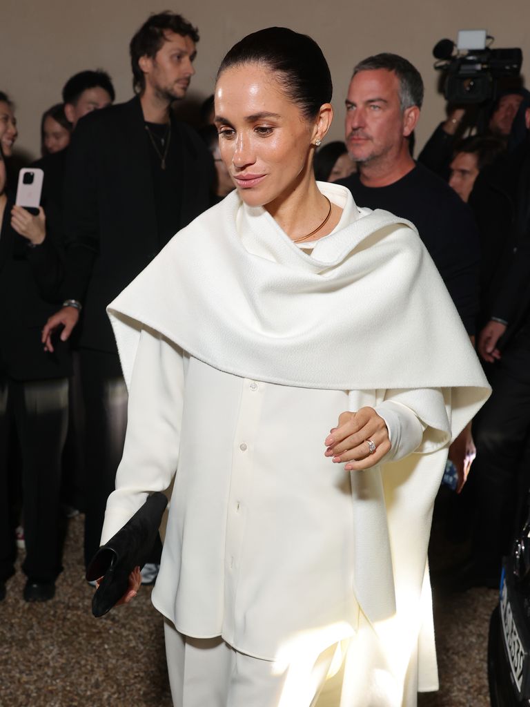 Meghan Markle in white outfit with hair in bun