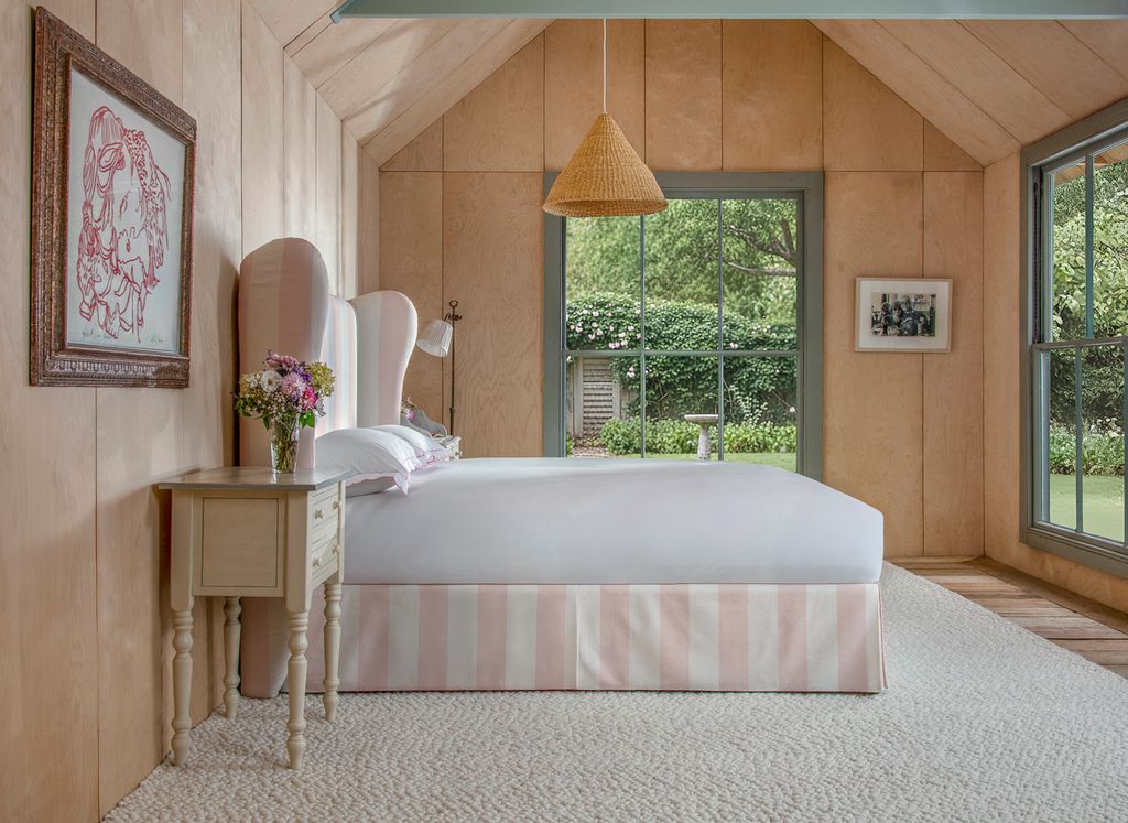 striped bed in large bedroom