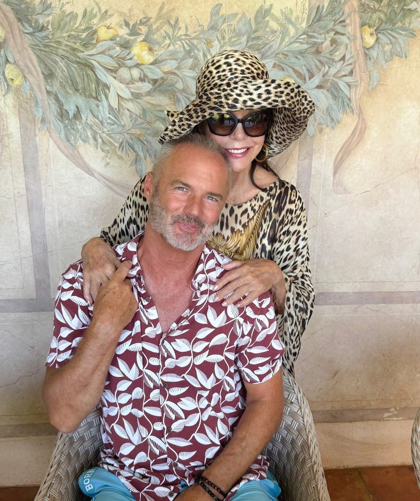 joan collins in leopard print outfit and hat