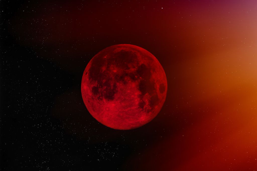 Blood Vanpire Moon against starry sky.