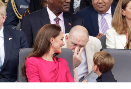 Prince Louis being jokingly told off by someone sat behind him and Princess Kate