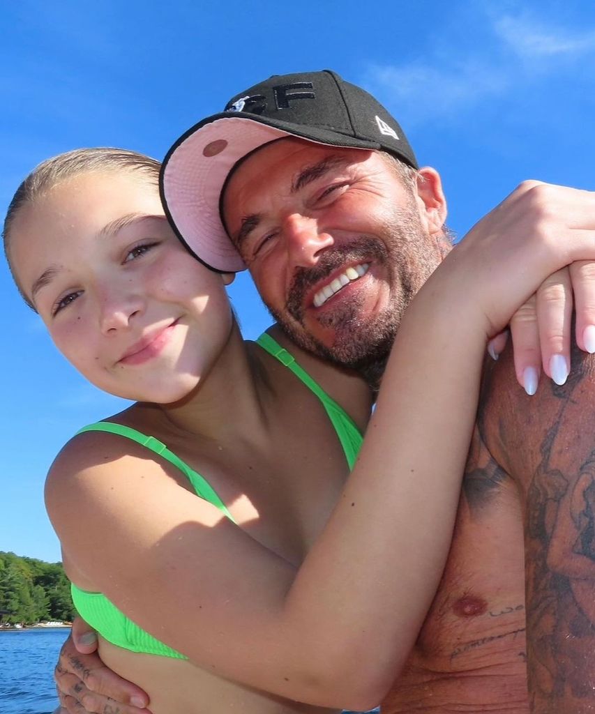 Harper Beckham hugging David Beckham