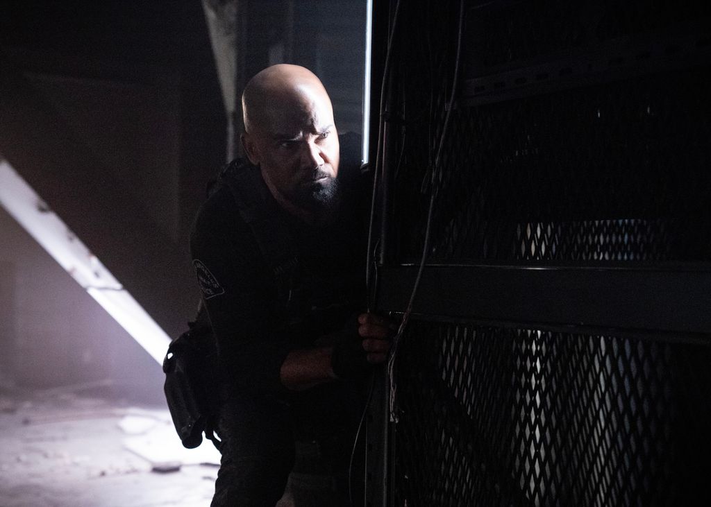 Shemar Moore as Daniel Harrelson hides behind a metal container in SWAT series finale
