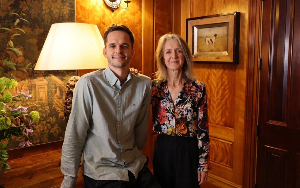 Dr Clare and Dr Jack  in wood panelled room smiling at camera