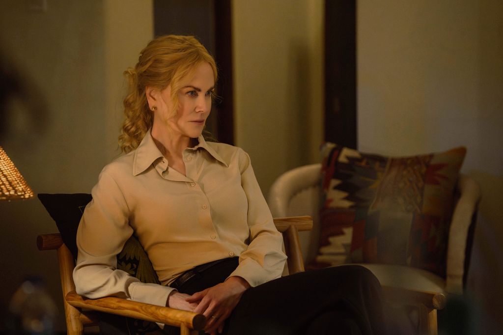 woman sitting on chair in beige shirt