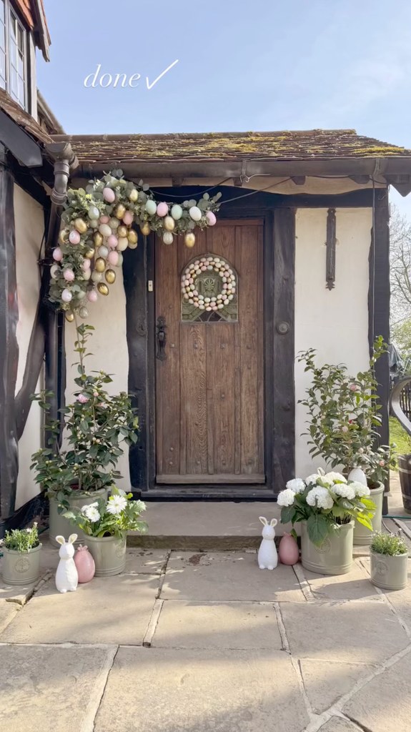 wooden front door of house decorated with Easter eggs and Easter bunnies