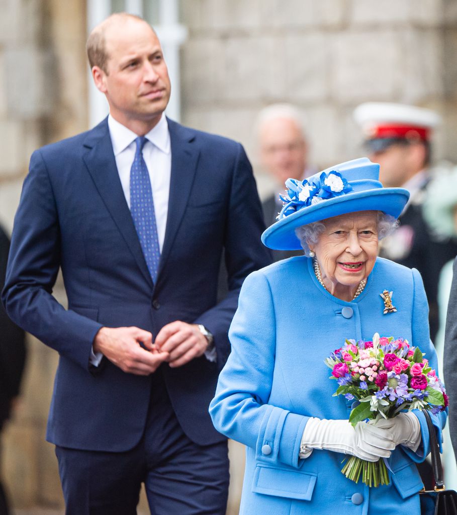 Prince William in suit with queen elizabeth in blue coat and hat