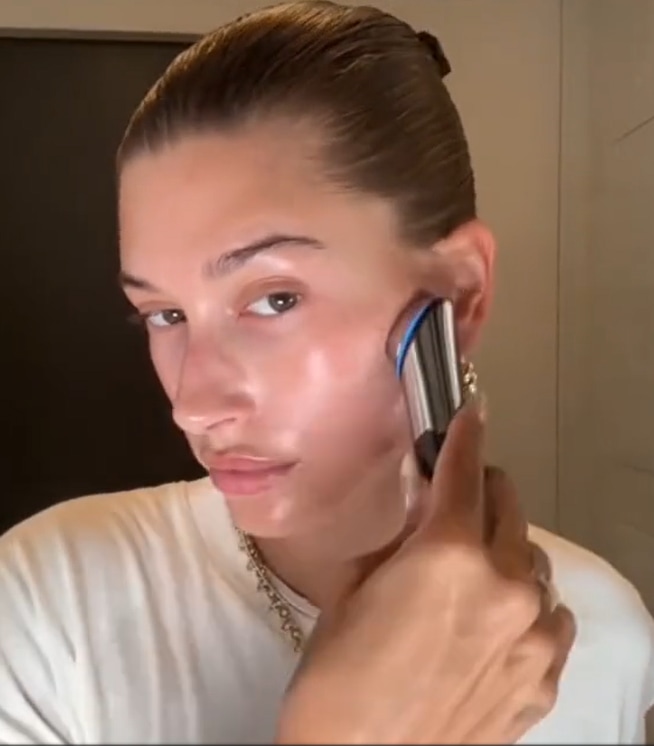 hailey bieber using a medicube skincare tool