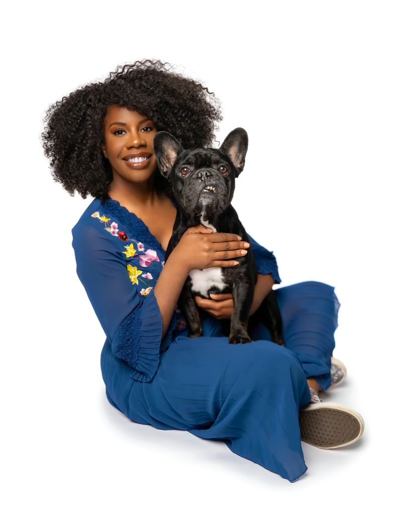 woman in blue clothes holding French bulldog