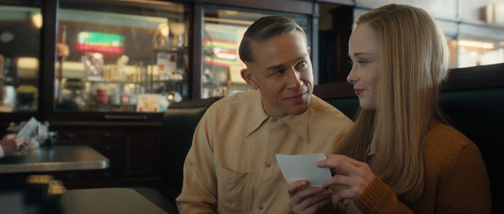 man and woman sitting in booth in diner