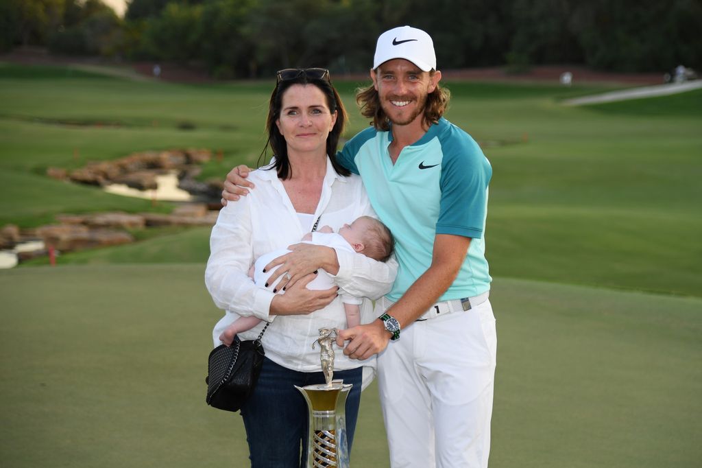tommy fleetwood on course with wife holding baby