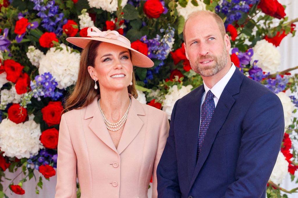 woman and man in formal wear against floral backdrop