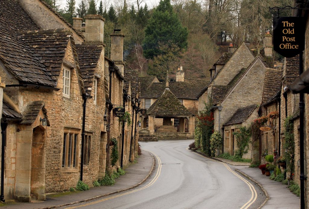 Tourism Boost As Historic Wiltshire Villages Benefit From Filming. An image old, yellow stone cottages and a quiet road