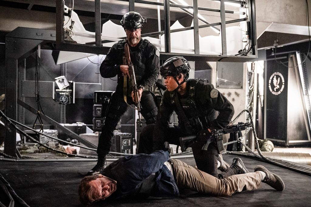 Jay Harrington as David Kay and David Lim as Victor Tan stand over a suspect in SWAT series finale