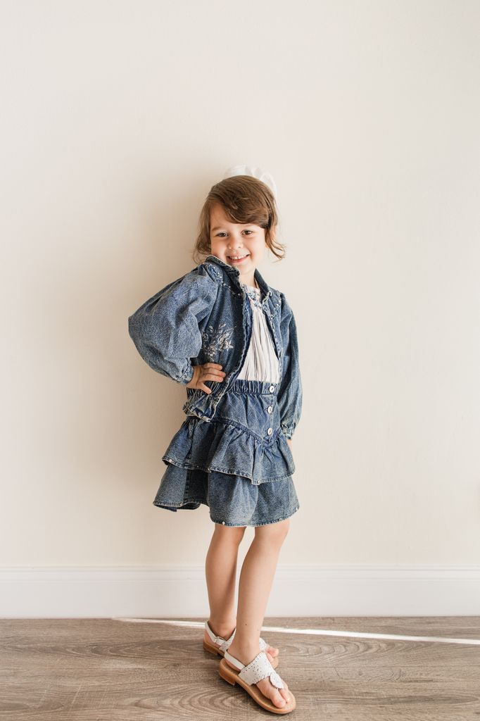 little girl wearing denim skirts