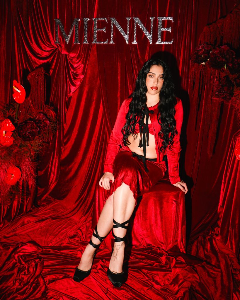 lourdes leon in red outfit sitting in red room