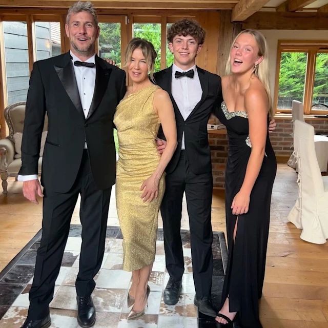 Renee Zellweger in a golden dress and Ant Antstead in a black suit posing with his oldest two children