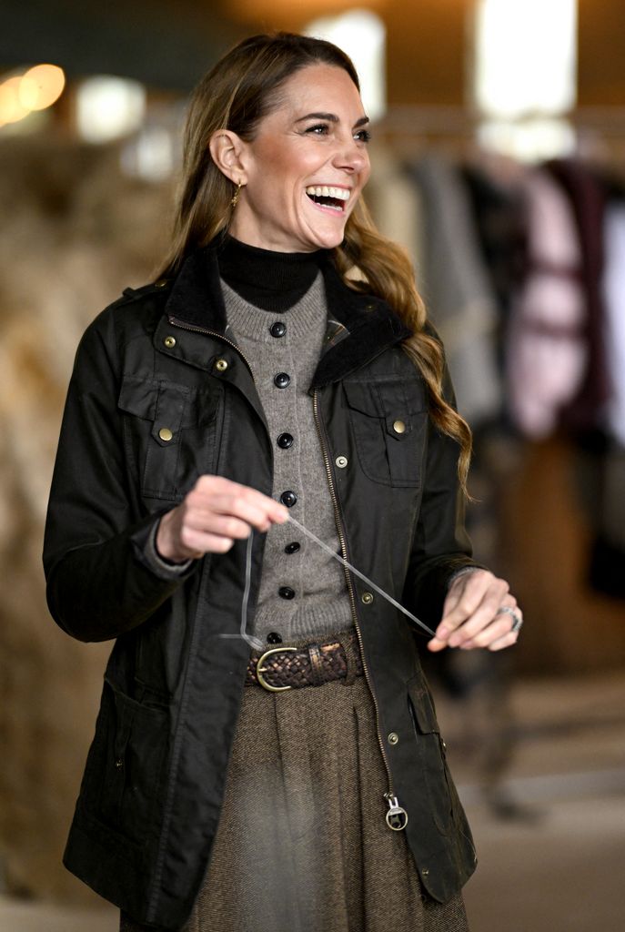 Princess of Wales laughing in cardigan and khaki waxed jacket