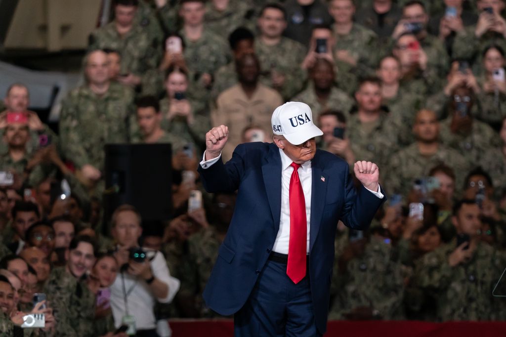 Donald Trump dances after speaking to troops aboard USS George Washington on October 28, 2025 in Yokosuka, Japan