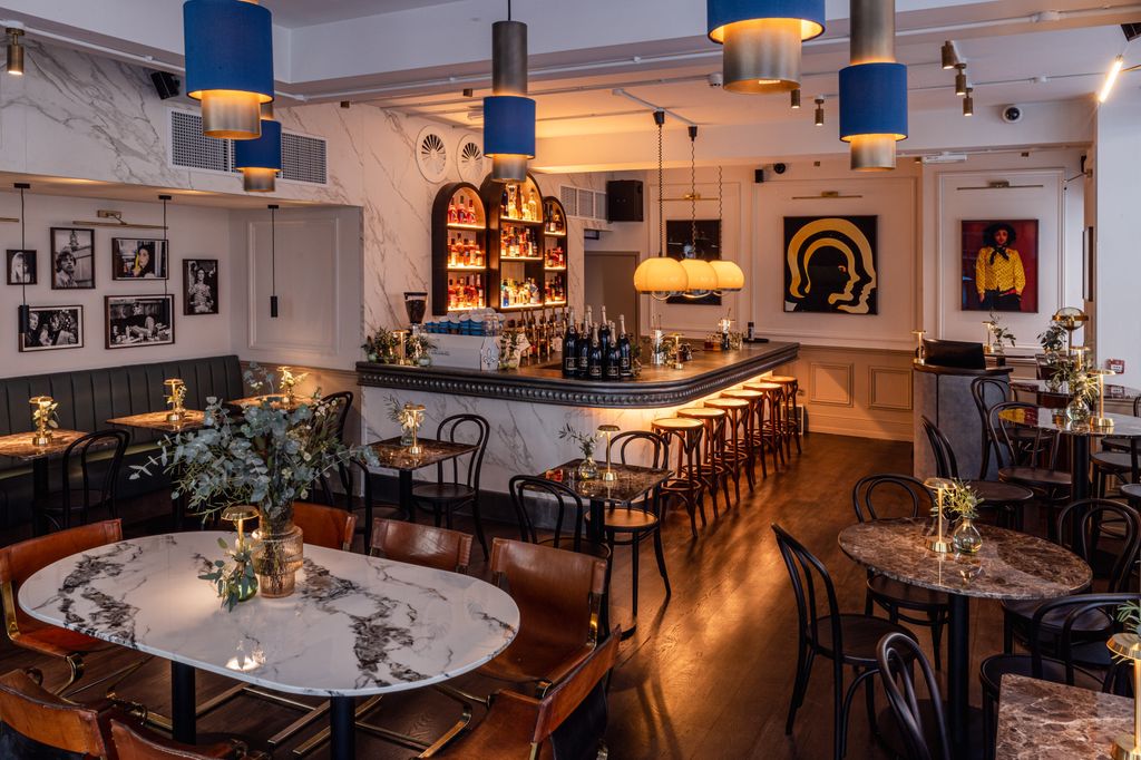 restaurant with white marble walls and mahogany floors