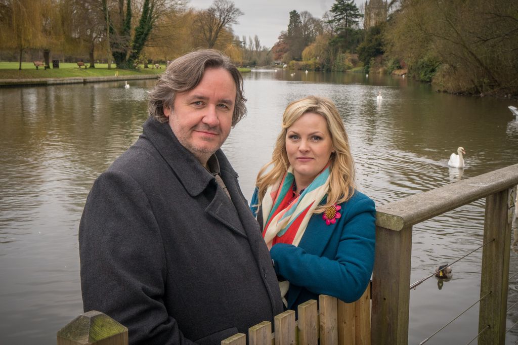 man and woman standing by river