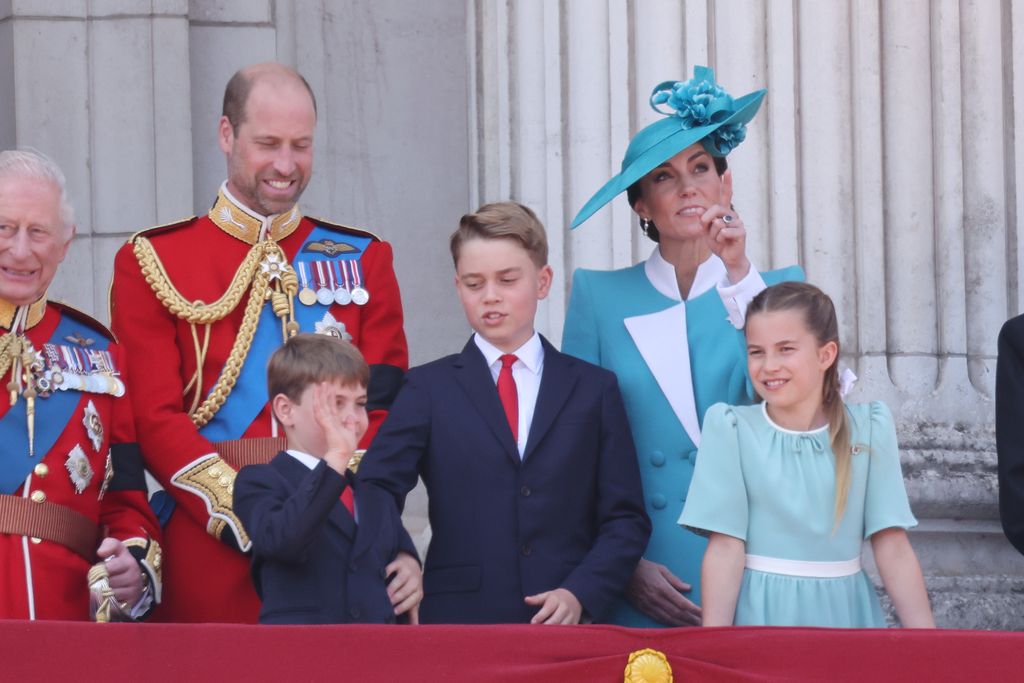 George nudges Louis while he's waving