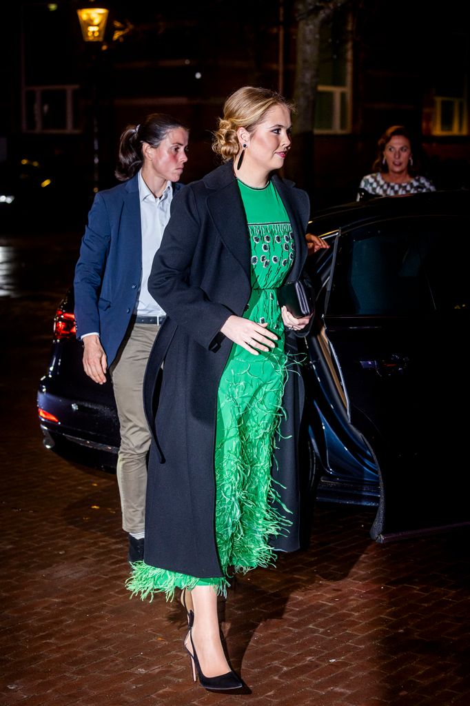 Princess Amalia exiting car in emerald dress and black coat