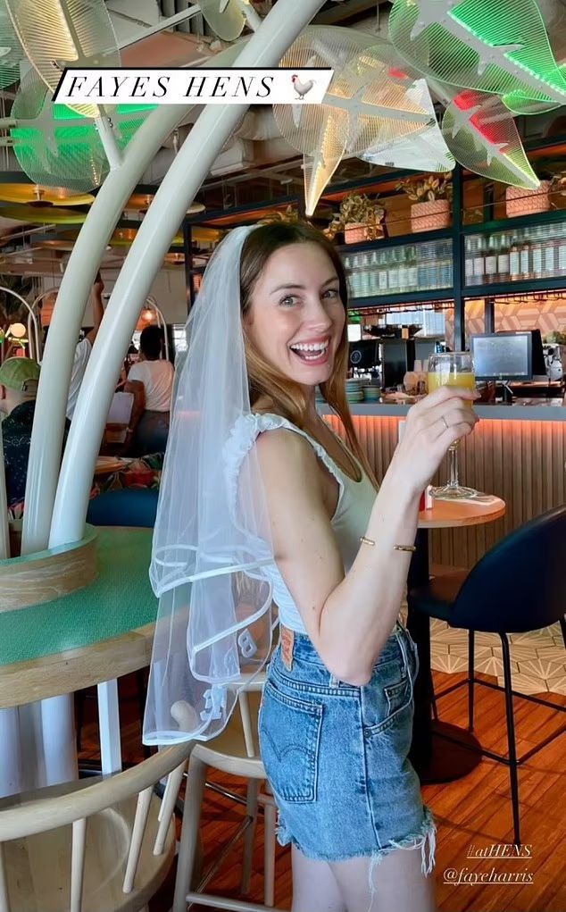 Faye Harris in denim shorts and a veil