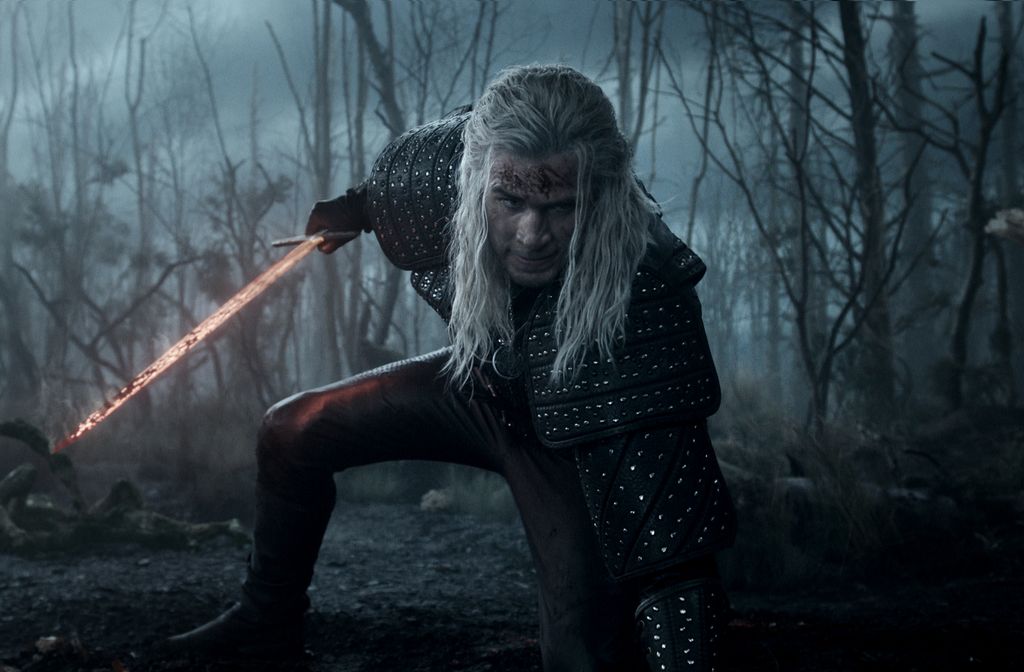 Liam Hemsworth holding a sword while in costume as Geralt of Rivia 