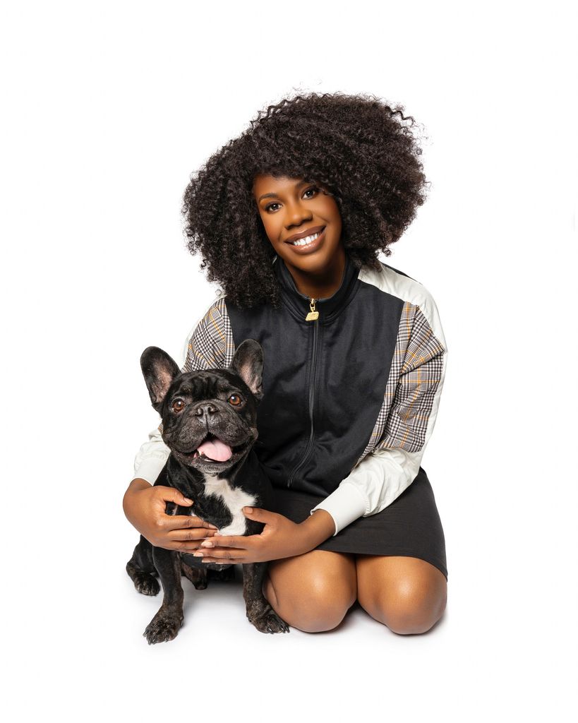 woman sat next to French bulldog
