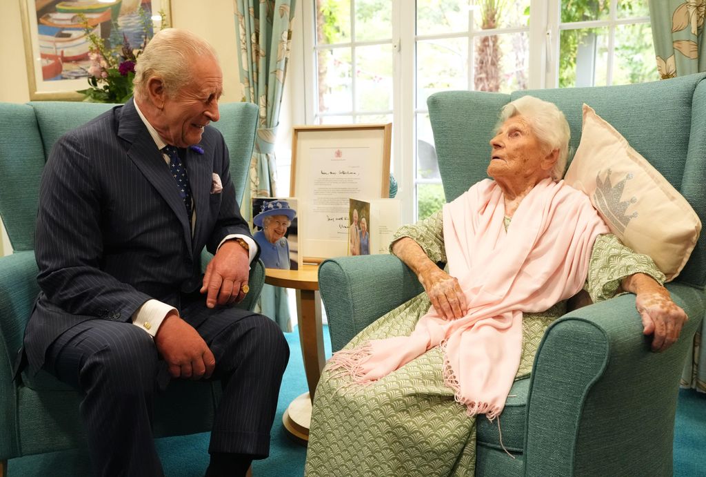King Charles laughing at a comment from Ethel Caterham