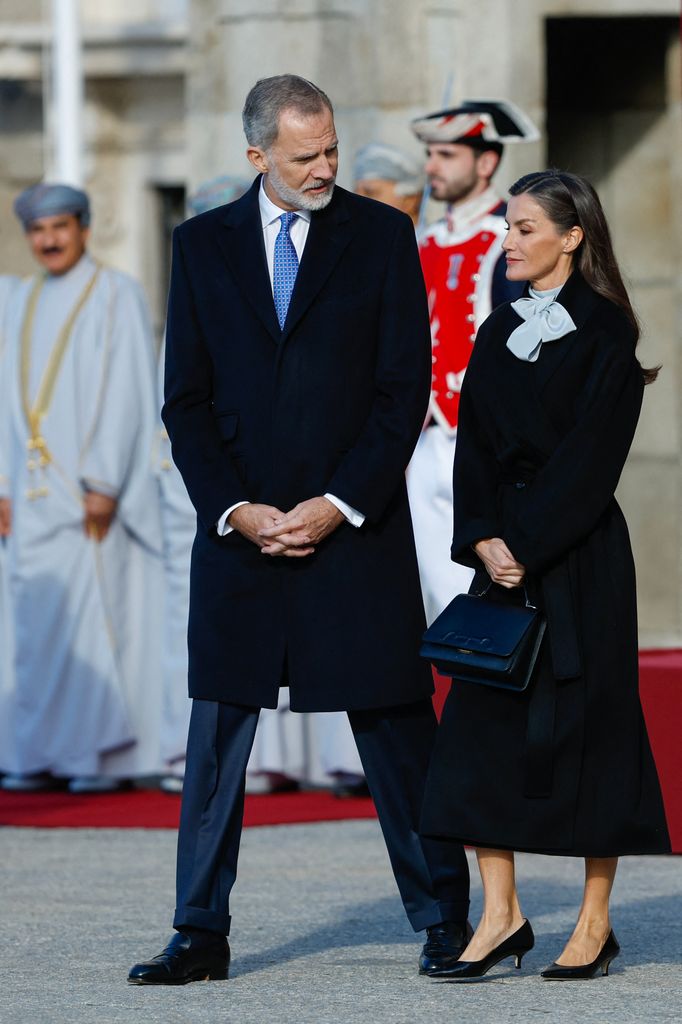 Spain's King Felipe VI talks to Queen Letizia during a welcome ceremony for Sultan of Oman Haitham bin Tariq at the Royal Palace in Madrid