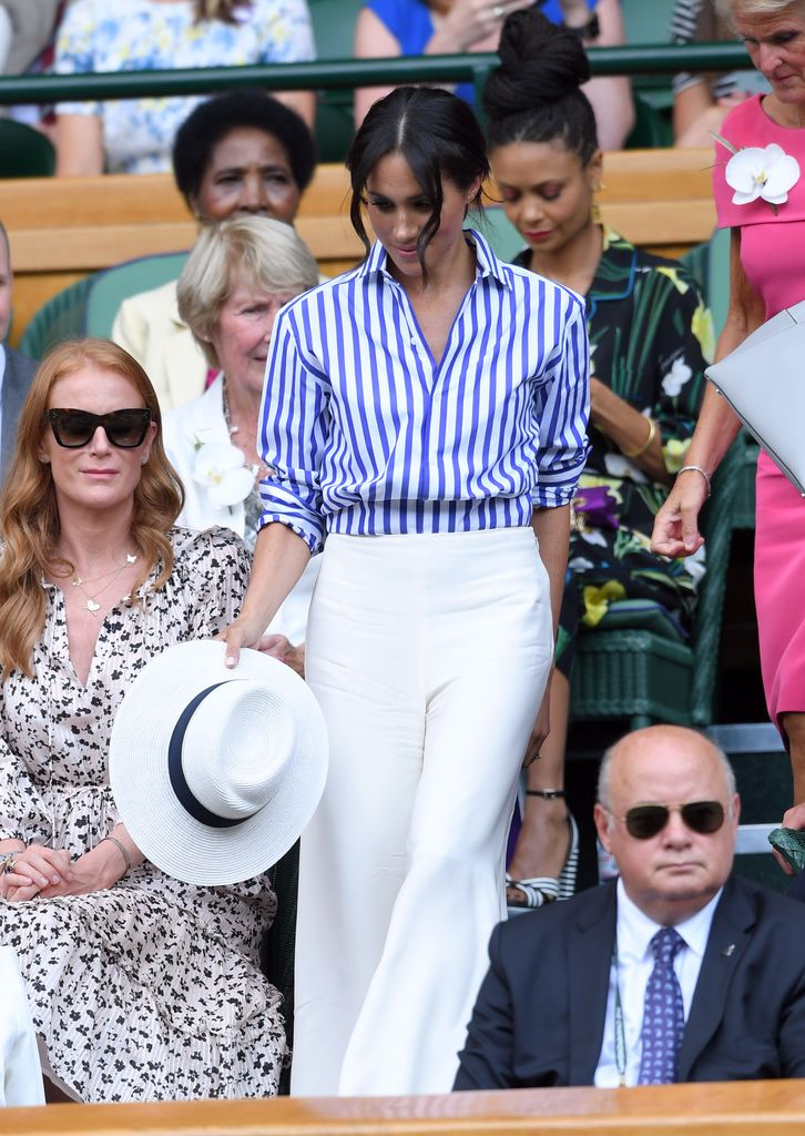Meghan Markle wearing striped shirt and white trousers to Wimbledon 2018
