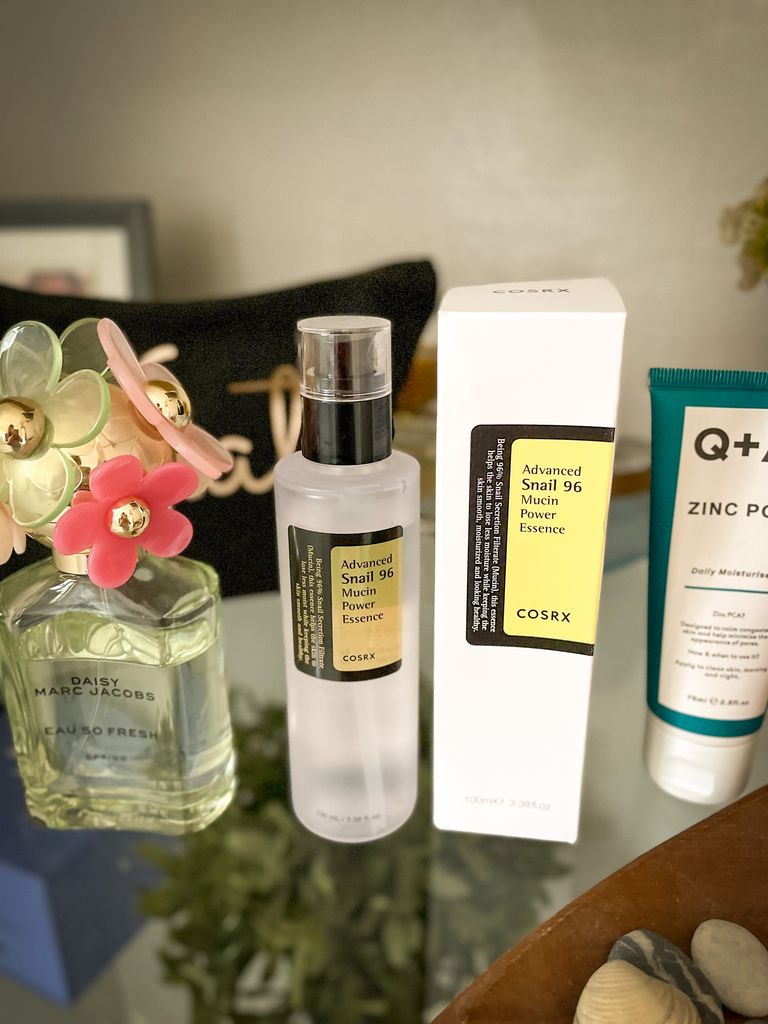 Snail mucin product on a bathroom shelf