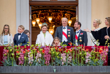 Prince Sverre Magnus of Norway pulling a funny face on the balcony surrounded by royals