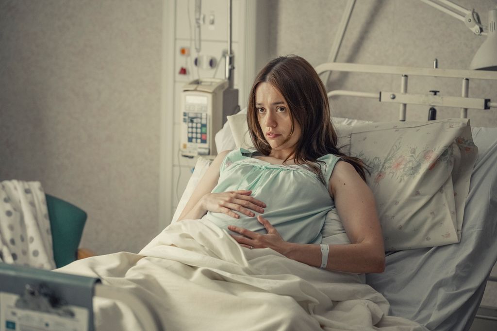 Pregnant woman lying in hospital bed